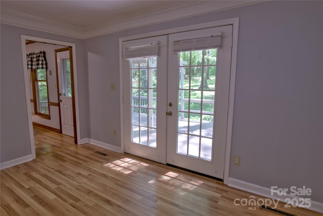 10708 Danesway Ln, Cornelius, NC 28031 - doorway to outside with french doors, baseboards, ornamental molding, and light wood-style flooring