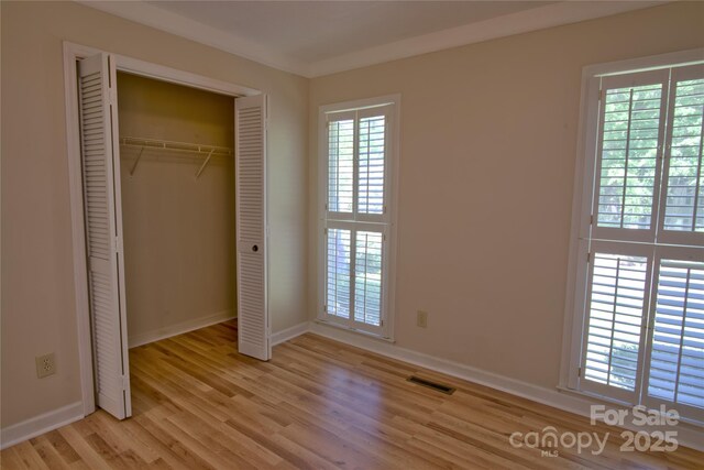 10708 Danesway Ln, Cornelius, NC 28031 - unfurnished bedroom with light wood finished floors, baseboards, a closet, and visible vents