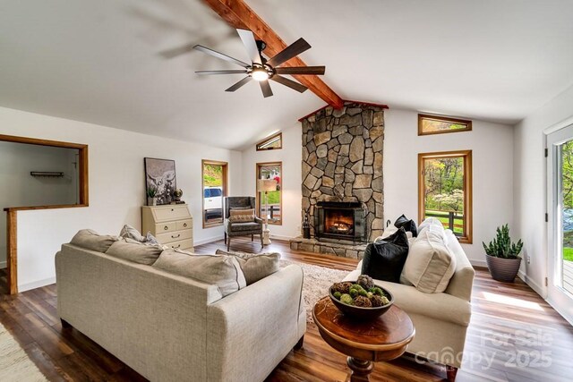 living area with dark wood-style flooring, a fireplace, baseboards, ceiling fan, and lofted ceiling with beams