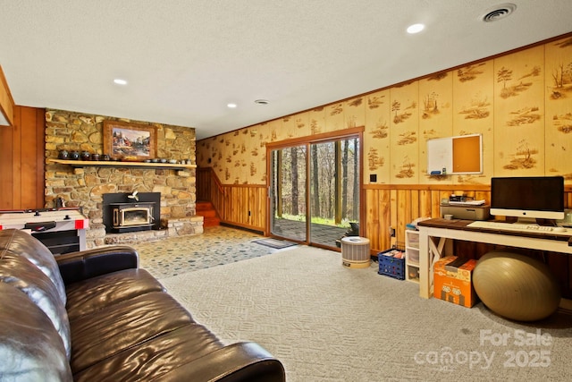 675 Rodgers Rd, Newland, NC 28657 - living room featuring wainscoting, visible vents, wooden walls, carpet floors, and a wood stove