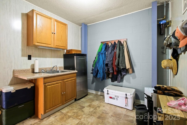 675 Rodgers Rd, Newland, NC 28657 - kitchen with light countertops, freestanding refrigerator, a textured ceiling, and a sink
