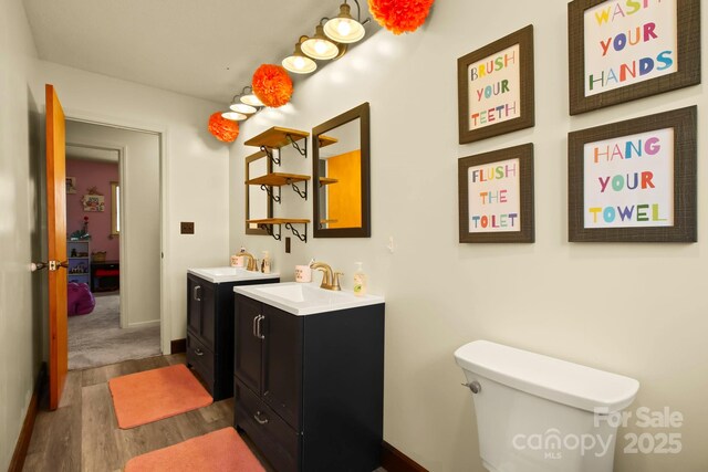 675 Rodgers Rd, Newland, NC 28657 - bathroom with toilet, vanity, wood finished floors, and baseboards