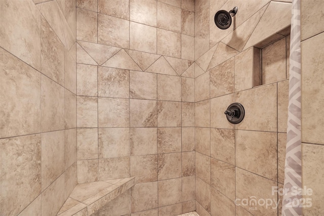 interior details with a tile shower