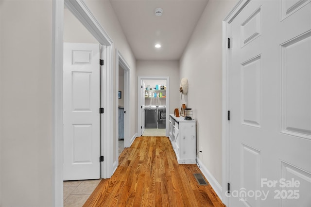 hall featuring recessed lighting, visible vents, light wood finished floors, and baseboards