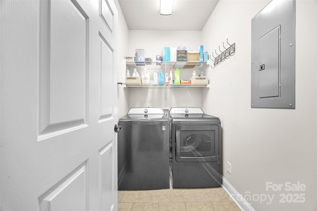 clothes washing area with laundry area, light tile patterned flooring, electric panel, baseboards, and separate washer and dryer