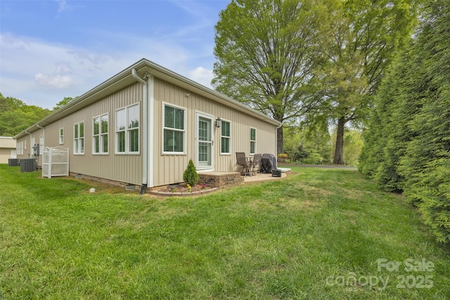 view of side of property with central AC unit, a lawn, board and batten siding, crawl space, and a patio