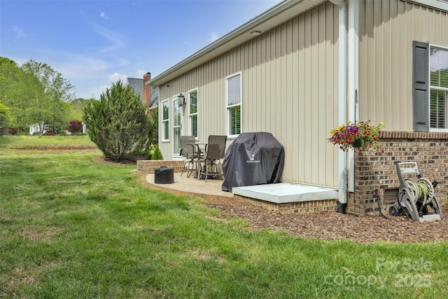 back of property with a patio area and a lawn