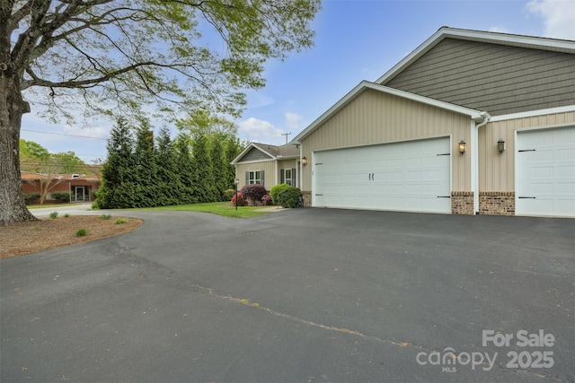 view of front of property with an attached garage and aphalt driveway