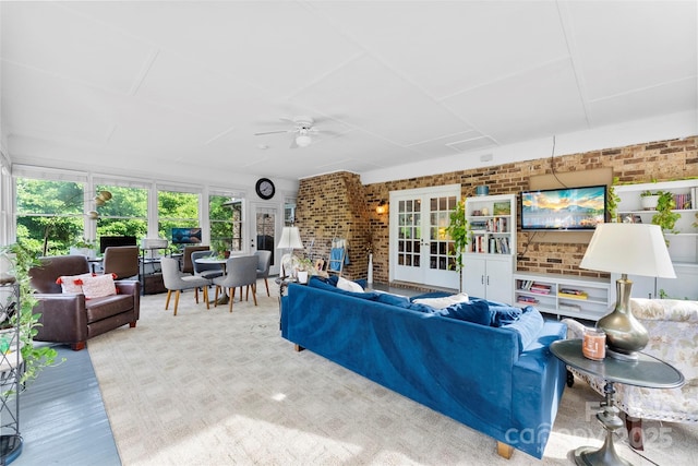 living room with french doors, brick wall, and ceiling fan
