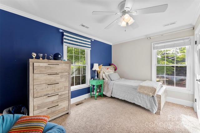 bedroom featuring visible vents, carpet flooring, baseboards, and crown molding