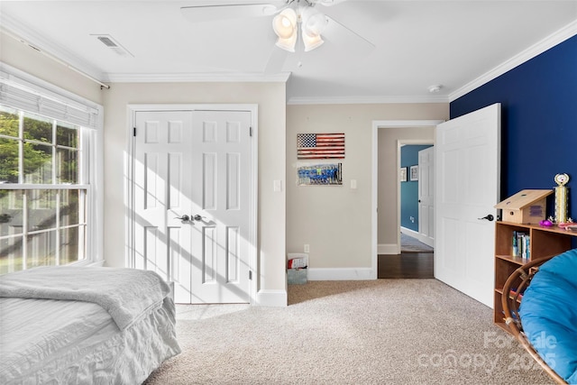 bedroom featuring visible vents, ornamental molding, baseboards, ceiling fan, and carpet