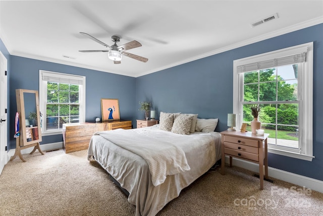 bedroom with crown molding, baseboards, visible vents, and carpet