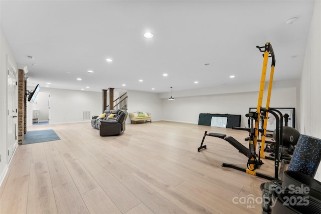 exercise room with visible vents, recessed lighting, baseboards, and wood finished floors
