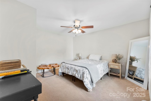 carpeted bedroom with baseboards and a ceiling fan