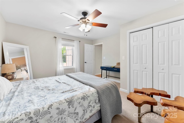 carpeted bedroom featuring baseboards, ceiling fan, a closet, and visible vents