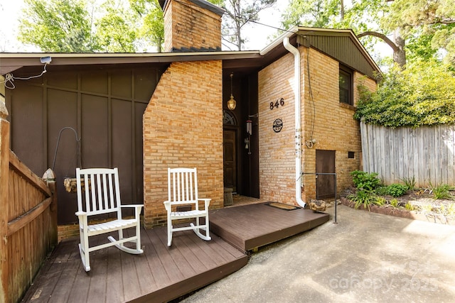 846 Gist Rd, Rock Hill, SC 29732 - rear view of house with fence, brick siding, board and batten siding, a deck, and a chimney