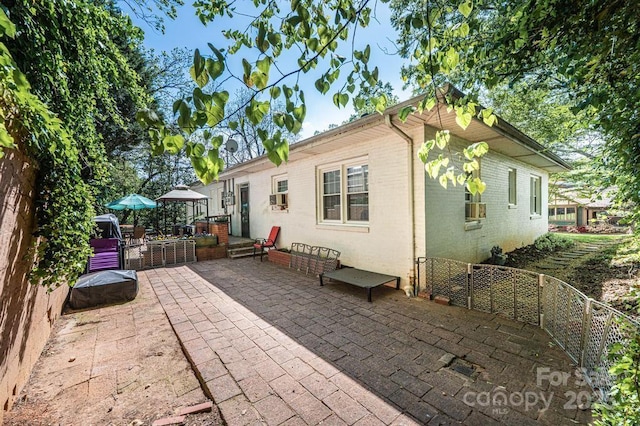 310 1st St NE, Hickory, NC 28601 - rear view of property with brick siding, fence, and a patio area