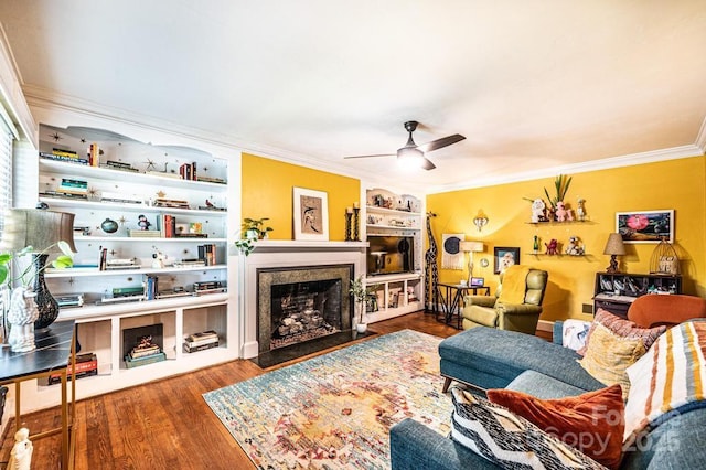 310 1st St NE, Hickory, NC 28601 - living room with a ceiling fan, crown molding, wood finished floors, built in features, and a fireplace