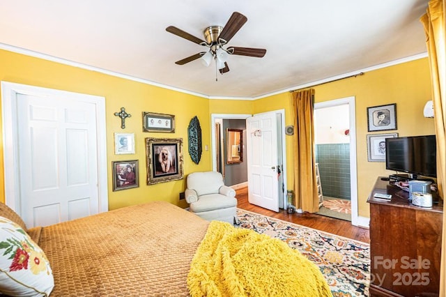 310 1st St NE, Hickory, NC 28601 - bedroom with crown molding, wood finished floors, ensuite bathroom, ceiling fan, and baseboards