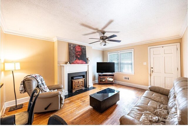 310 1st St NE, Hickory, NC 28601 - living area featuring ceiling fan, crown molding, a textured ceiling, and visible vents