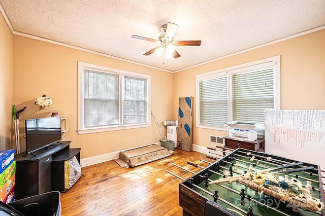 310 1st St NE, Hickory, NC 28601 - recreation room featuring crown molding, ceiling fan, a wealth of natural light, wood-type flooring, and visible vents