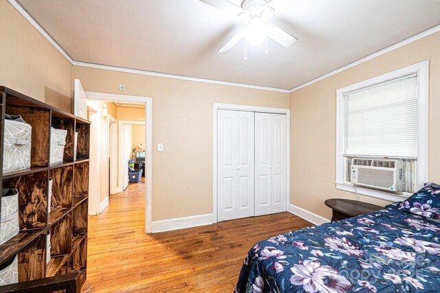 310 1st St NE, Hickory, NC 28601 - bedroom featuring wood finished floors, a closet, crown molding, cooling unit, and baseboards