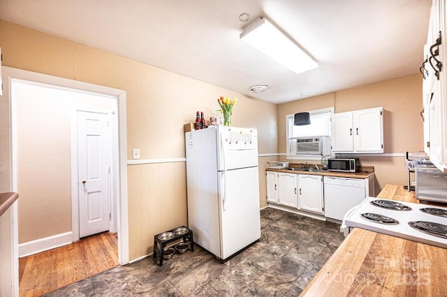 310 1st St NE, Hickory, NC 28601 - kitchen featuring white appliances, a sink, white cabinetry, and stone finish flooring