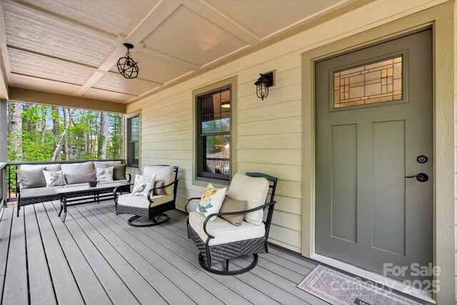 deck featuring a porch and an outdoor hangout area