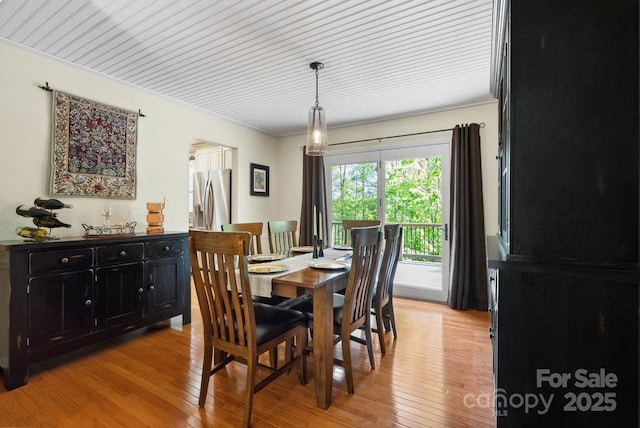 dining room featuring crown molding and light wood finished floors