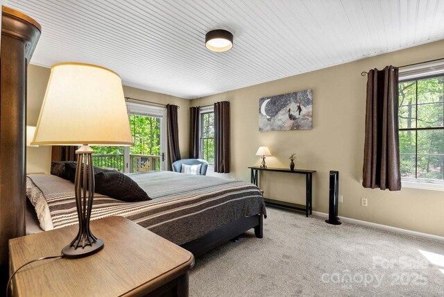 carpeted bedroom with multiple windows and baseboards
