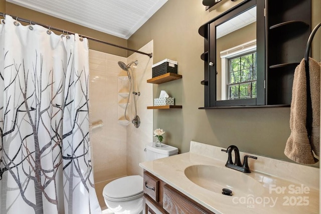 bathroom with toilet, a tile shower, and vanity