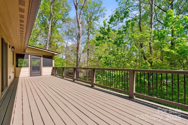 wooden deck with a sunroom