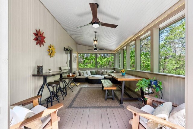 sunroom with outdoor dry bar, ceiling fan, and an outdoor living space