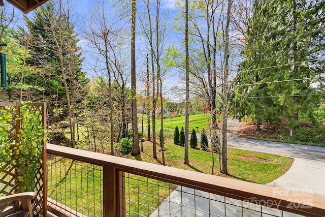 wooden deck with a lawn