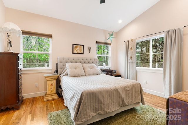 bedroom with vaulted ceiling, ceiling fan, light wood finished floors, baseboards, and recessed lighting