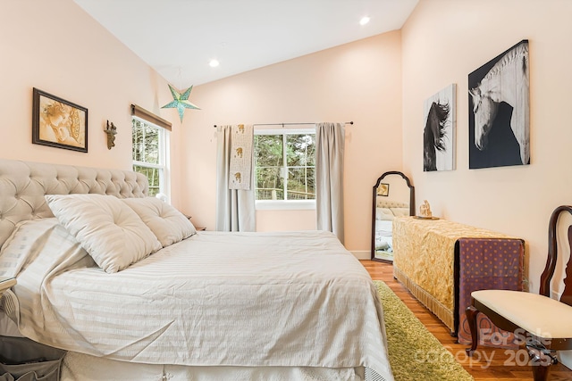 bedroom with recessed lighting, vaulted ceiling, and wood finished floors
