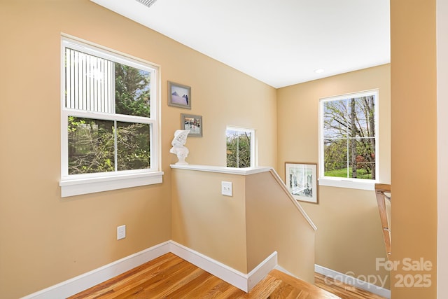 stairs featuring wood finished floors and baseboards