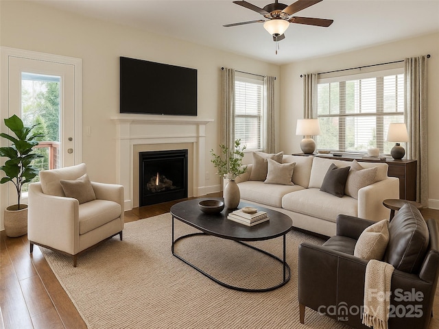 19 Tudor Way, Black Mountain, NC 28711 - living room featuring ceiling fan, wood finished floors, and a warm lit fireplace