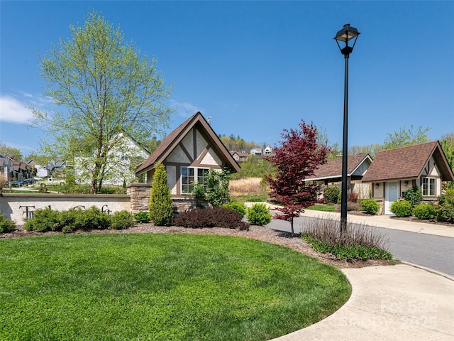 19 Tudor Way, Black Mountain, NC 28711 - tudor-style house with a front lawn and stucco siding