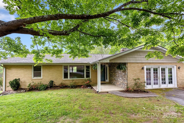 159 Amble Ln, Fletcher, NC 28732 - ranch-style house featuring a front lawn, brick siding, a chimney, and a patio area