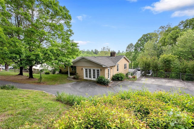 159 Amble Ln, Fletcher, NC 28732 - single story home featuring french doors, fence, a chimney, a front yard, and driveway