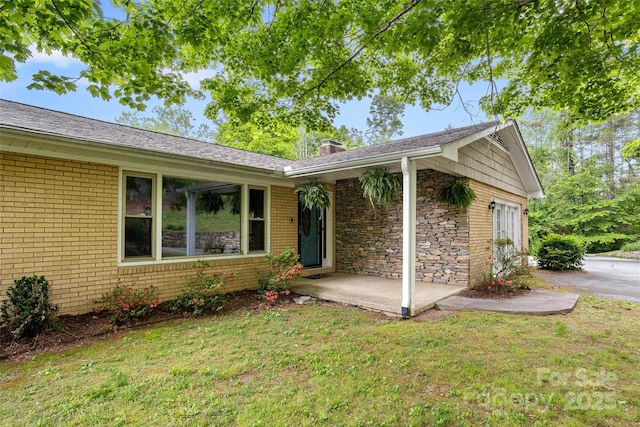 159 Amble Ln, Fletcher, NC 28732 - entrance to property with a lawn, a chimney, brick siding, and stone siding