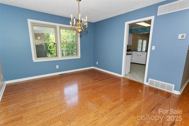 159 Amble Ln, Fletcher, NC 28732 - spare room with an inviting chandelier, visible vents, and baseboards