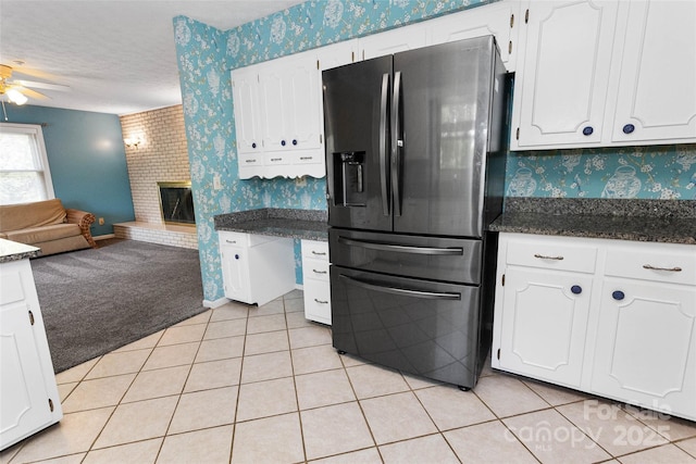 159 Amble Ln, Fletcher, NC 28732 - kitchen featuring black refrigerator with ice dispenser, white cabinetry, open floor plan, a ceiling fan, and wallpapered walls