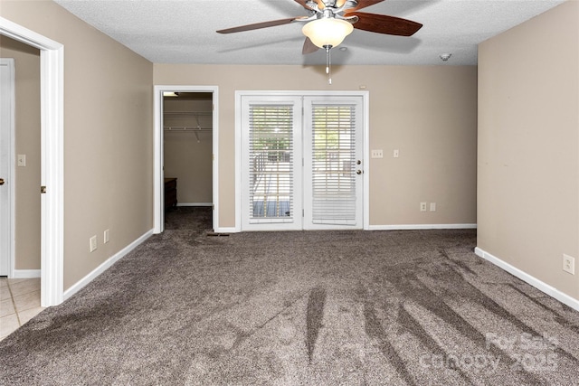 159 Amble Ln, Fletcher, NC 28732 - unfurnished bedroom featuring a spacious closet, a textured ceiling, and carpet
