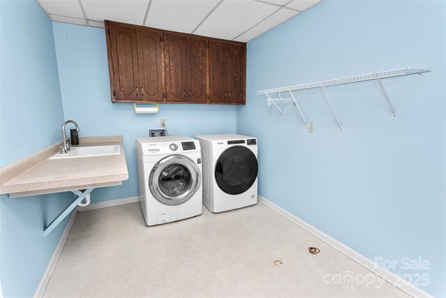 159 Amble Ln, Fletcher, NC 28732 - washroom with light floors, baseboards, a sink, washer and clothes dryer, and cabinet space