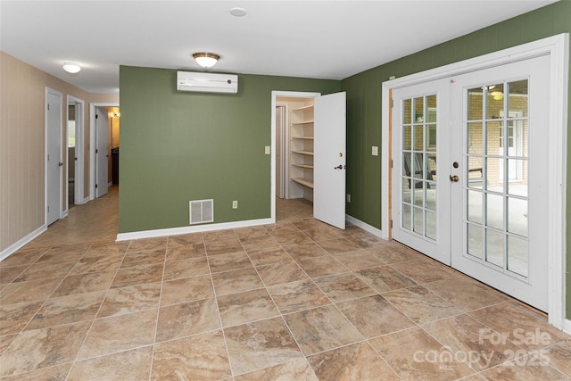 159 Amble Ln, Fletcher, NC 28732 - spare room featuring visible vents, french doors, baseboards, and an AC wall unit
