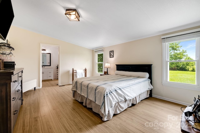 37 Bittersweet Dr, Hendersonville, NC 28792 - bedroom featuring light wood-type flooring, vaulted ceiling, baseboards, and ensuite bathroom