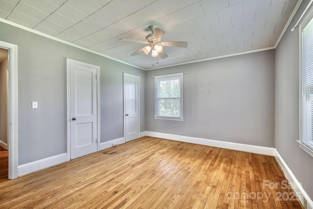 4897 Calico Rd, Lenoir, NC 28645 - unfurnished bedroom featuring ornamental molding, light wood-style flooring, and a ceiling fan