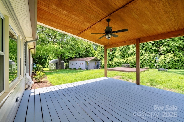 4897 Calico Rd, Lenoir, NC 28645 - deck with an outbuilding, a ceiling fan, and a yard